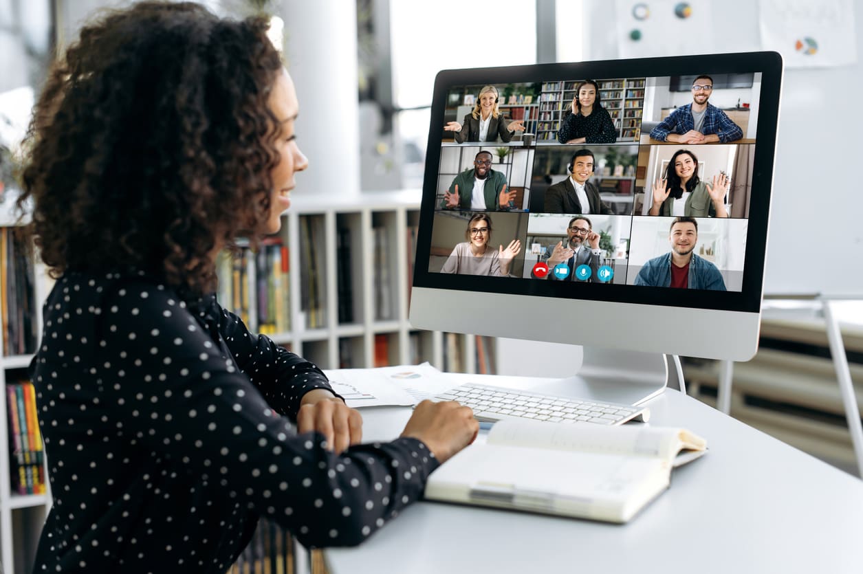 Woman participating in online video conference meeting.