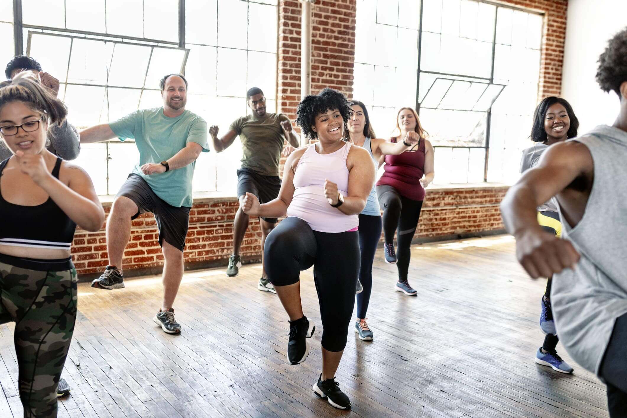 Group fitness class in bright studio.