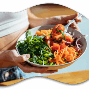 Person holding a colorful salad bowl.