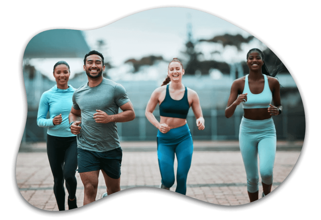 Four people jogging outdoors, smiling together. Four people jogging outdoors, smiling together.